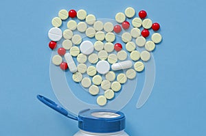 White heart pills on a colored background.