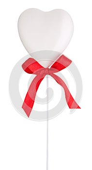 White heart and red ribbon with a bow Isolated on white