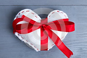 White heart with red ribbon bow on Valentine`s Day