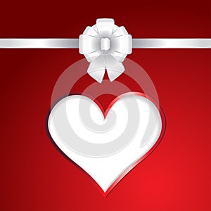 White heart and ribbon bow on red background