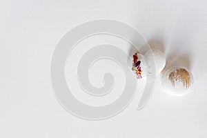 A white heart-shape cake lies on a white plate on a light background. Light macaroons. Delicious pastries