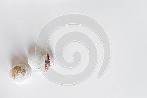 A white heart-shape cake lies on a white plate on a light background. Light macaroons. Delicious pastries