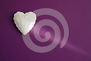 White heart on violet purple background. Valentine`s day, anniversary, mother`s day, marriage concept, invitation e-card. Copy