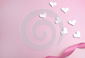 White hearts and ribbon on pink background. Love minimalist composition