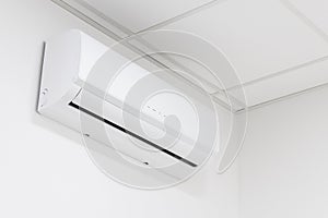 White heating and cooling air conditioner on white wall in office or home