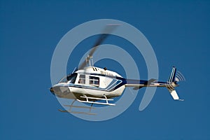 White helicopter in flight