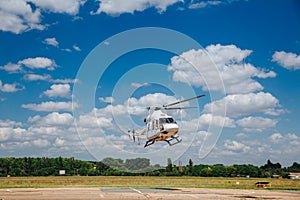 White helicopter takes off from the take-off area