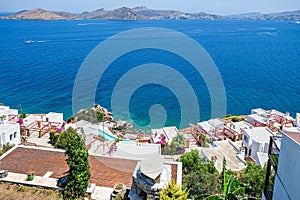 White holiday villas houses on resort with sea view and swimming pool and palm trees