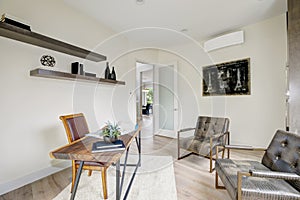 White home office interior furnished with leather chairs