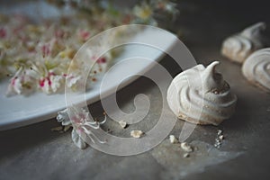 White homemade merengue cookies on parchment