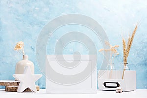 White horizontal Photo frame mock up with plants in vase, ceramic decor on shelf. Scandinavian style