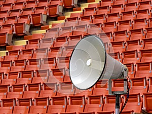 White horn speaker with stadium seat background