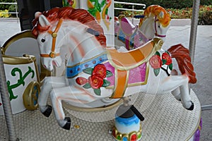 White horses on children`s carousel, close up