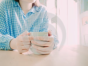 White hot coffee cup for drink in morning time in hand of beauty