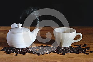 White Hot coffee cup with white pot and roasters bean photo