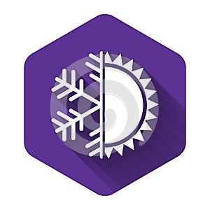 White Hot and cold symbol. Sun and snowflake icon isolated with long shadow. Winter and summer symbol. Purple hexagon