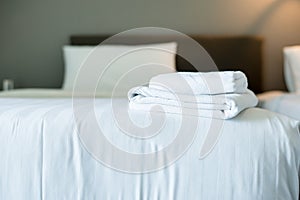 White hotel towel on bed,Stack of fluffy bath towels,Close up,Copy space for text