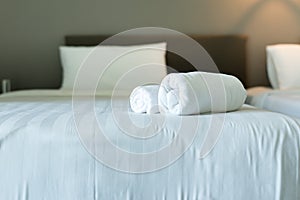 White hotel towel on bed,Stack of fluffy bath towels,Close up,Copy space for text