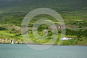 White house above the calm harbour of Akureyri
