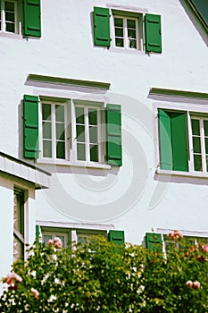 White house facade with green shutters