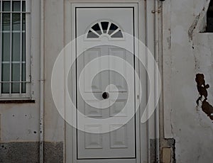 White House With Metal Door And Barred Window In Lagos Portugal