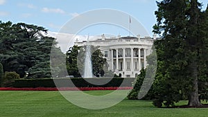 The white house and red flowers and fountain