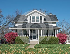 White House with Single Dormer and Open Porch with Railing