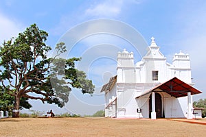 White house and tree on mountain peak