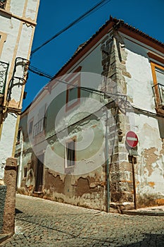 White houses with peeling plaster and NO ENTRY road sign