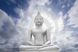 White image of Buddha with blue sky and cloud in background, light effect added ,filtered image,radial blurred sky,moving cloud