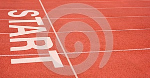 White imprint of the word START on running track, Starting point concept