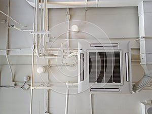 White Industrial air conditioner cooling pipe with plumbing at ceiling. Ventilation system ceiling air duct