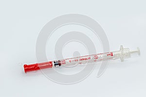 White insulin syringe macro on white surface