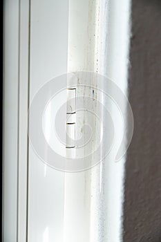 White interior hinge in pvc or plastic material. Detail of a door or window.