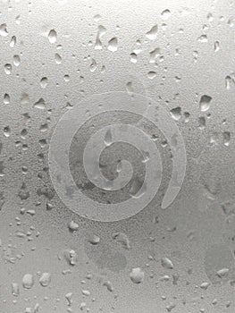 White isolated background water drops on the glass / wet window glass with splashes and drops of water. Texture autumn background