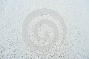 White isolated background water drops on glass wet window with splashes, texture autumn background