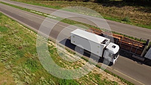 A white isothermal van is moving along the highway