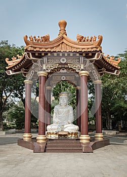 White Jade Gautama Buddha Statue Sitting on Lotus in pavilion