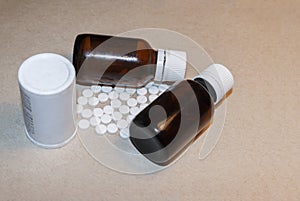 White jar of pills and two bottles of medical drugs