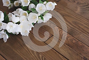 White Jasmine Flowers Little White Flowers on Brown Old Wooden Background. Space for text.