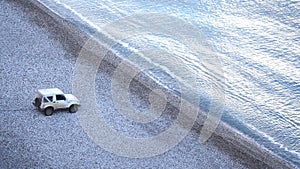 White Jeep on the stone beach