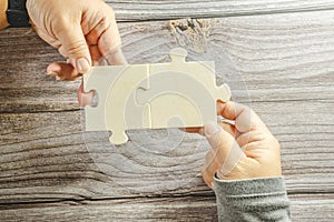 White jigsaw puzzle connecting together. Team business success partnership or teamwork concept. A group of business people