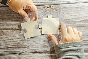 White jigsaw puzzle connecting together. Team business success partnership or teamwork concept. A group of business people