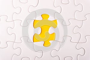 White jigsaw puzzle and missing pieces with selective focus