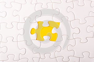 White jigsaw puzzle and missing pieces with selective focus