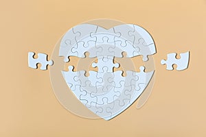 White jigsaw puzzle on the Yellow background. Completing final task, missing jigsaw puzzle pieces and business concept with a