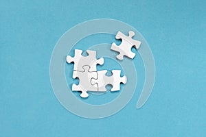 White jigsaw puzzles, on blue background