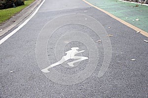 The white jogging man painting on the jogging lane parallel with green bike lane.