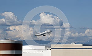 White Jumbo 747 above the airport