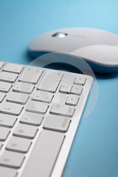 White Keyboard and Mouse on a blue table